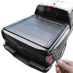 Black tonneau cover on Frontier with a hand holding a key fob.