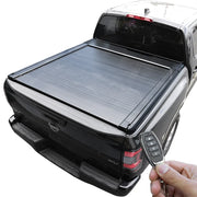 Black tonneau cover on Frontier with a hand holding a key fob.