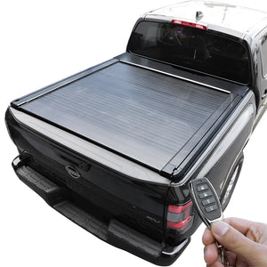 Black tonneau cover on Frontier with a hand holding a key fob.