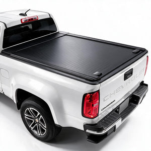 A black retractable truck bed cover installed on the bed of a white Chevrolet pickup truck, shown from a rear three-quarter angle against a plain white background.