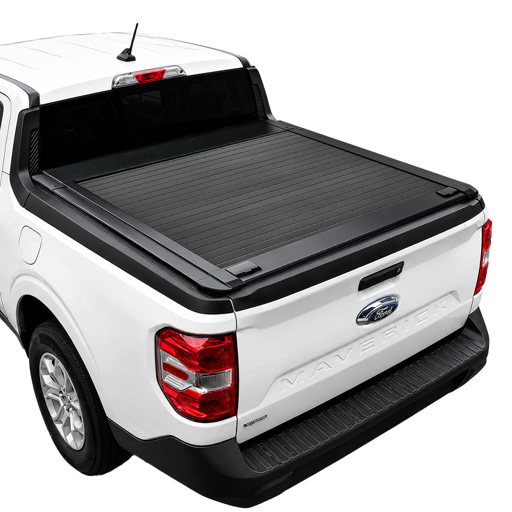 A black roll-up truck bed cover installed on the bed of a white Ford Maverick pickup truck, shown from a rear three-quarter angle against a solid white background.