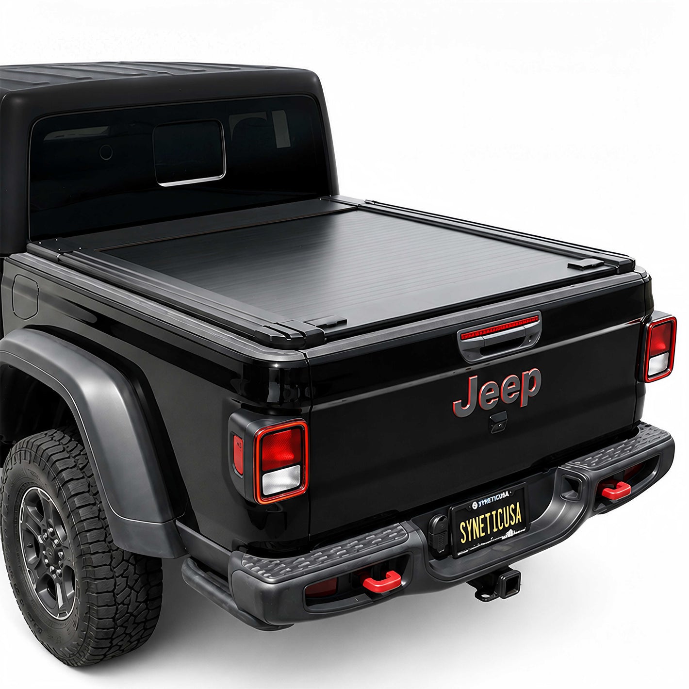 A black tonneau cover installed on the bed of a black Jeep Gladiator, shown from a rear three-quarter angle against a white studio background.