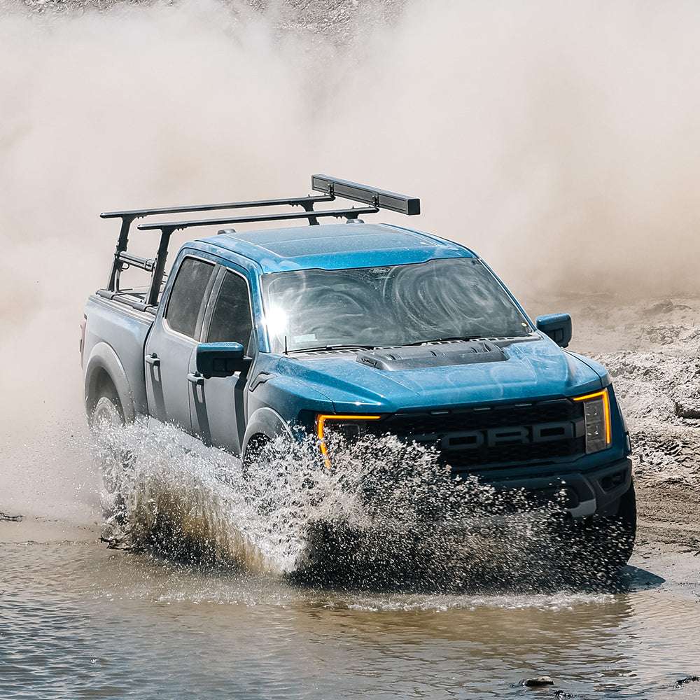 F-150 Raptor with syneticusa Tonneau Cover and Ladder Rack off-roading 