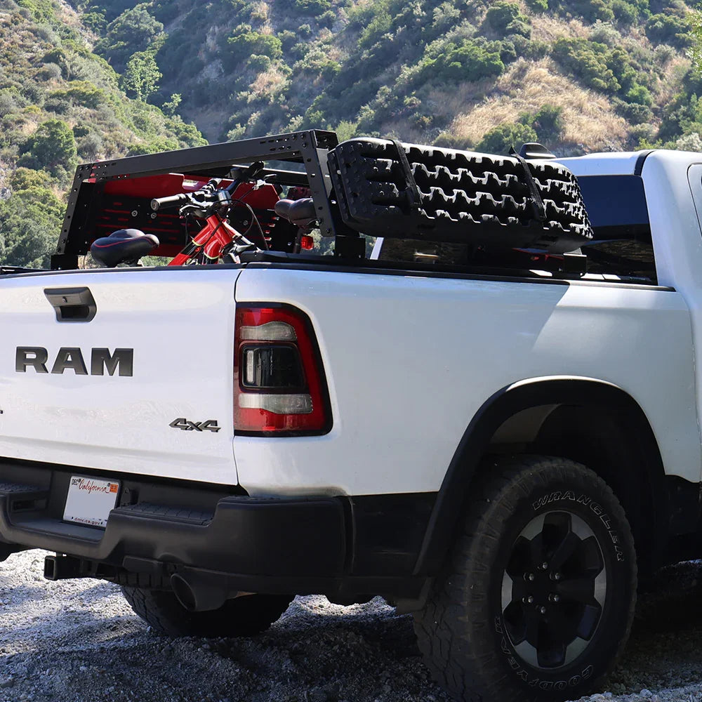 White RAM truck with off-road tires and equipment in a mountainous area