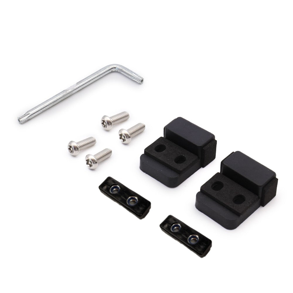Set of black block components and a silver tool on a white background