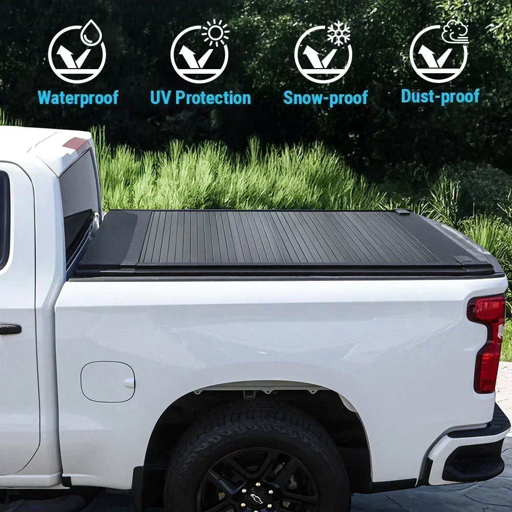 White truck with a syneticusa black tonneau cover parked outdoors