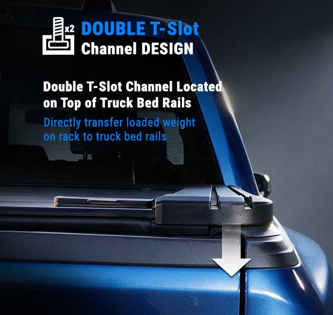 Close-up of the top edge of a blue truck bed showing a black T-slot channel mounted on the rails, with overlaid text explaining the double T-slot channel design and a white arrow pointing downward.