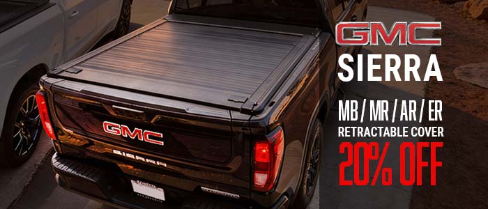 GMC Sierra truck bed with retractable cover and promotional text on a dark background