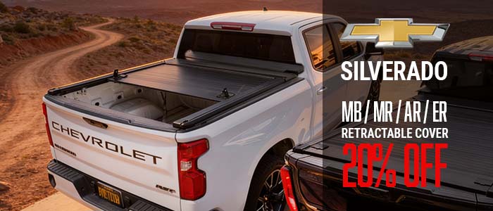 Chevrolet Silverado truck with a retractable cover and promotional text on a desert road.