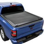 Blue Nissan Frontier with Enhanced MB retractable tonneau cover installed in a white background