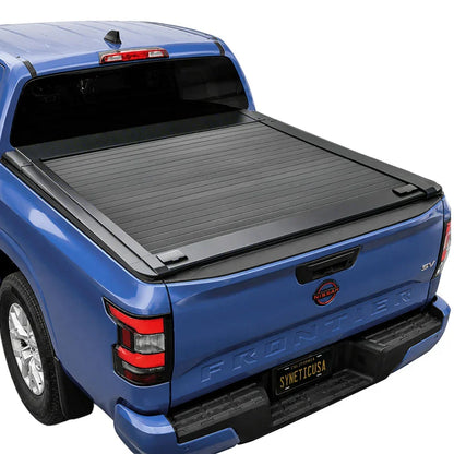 Blue Nissan Frontier with Enhanced MB retractable tonneau cover installed in a white background
