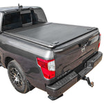 Gray Nissan Titan pickup truck with a MR tonneau cover on a white background