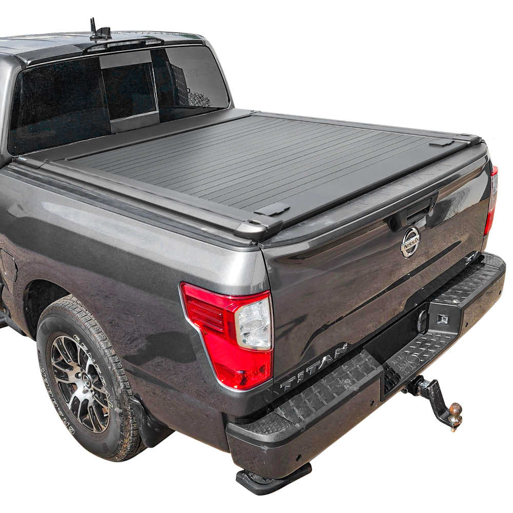 Gray Nissan Titan pickup truck with a MR tonneau cover on a white background