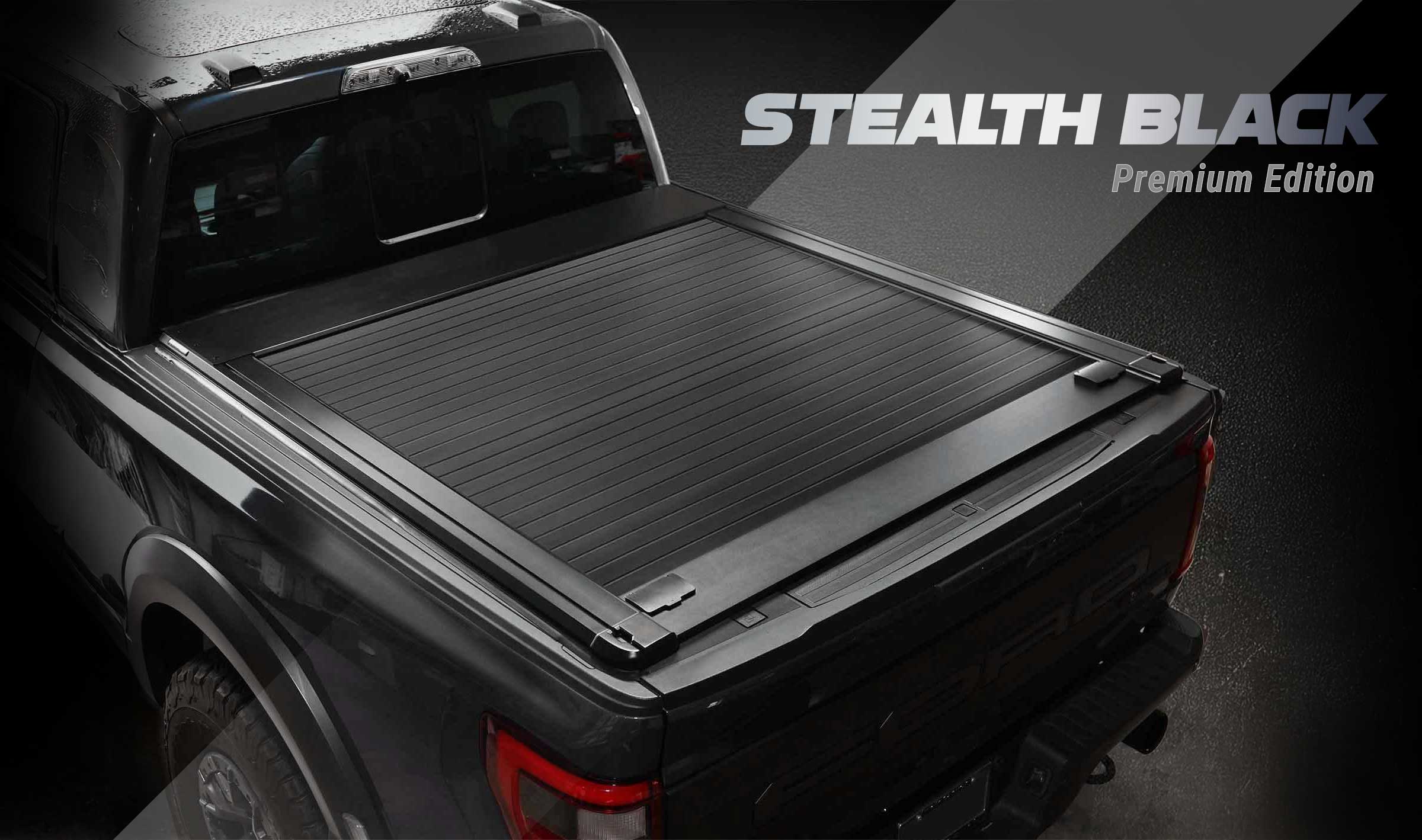 Black tonneau cover on a truck with 'Stealth Black Premium Edition' text.