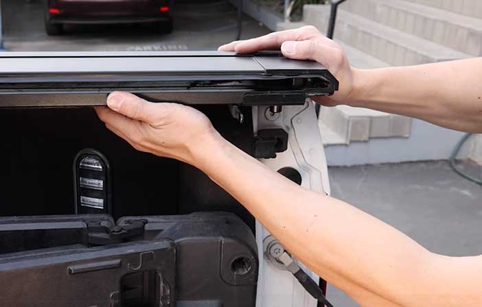 Person opening a vehicle's cargo area.