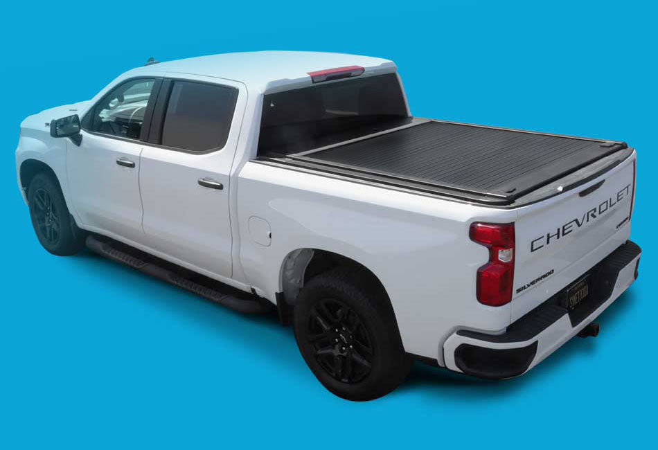 White Chevrolet truck with a tonneau cover on a blue background